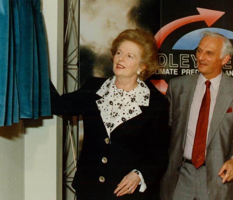 A man and woman standing next to a curtain at the Hadley Centre 30 years ago.