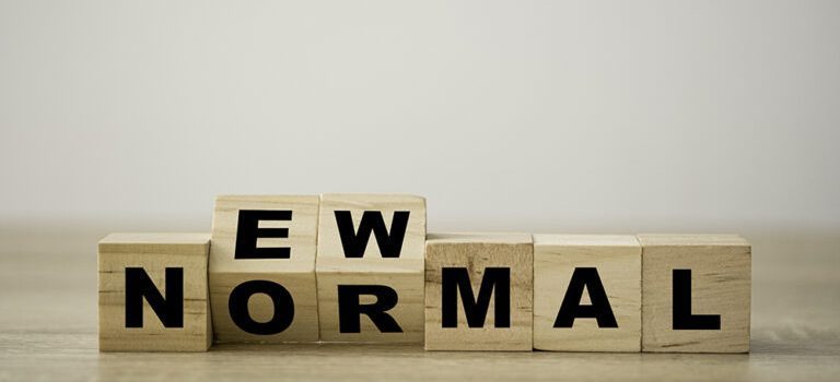 The word "new normal" spelled out in wooden cubes, reflecting multiple baselines and tolerances in climates.