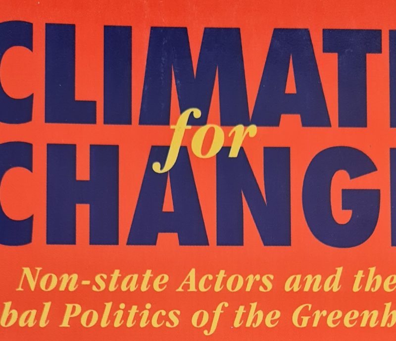 The image shows the 2000 Climate Book cover titled "Climate for Change: Non-state Actors and the Global Politics of the Greenhouse" on a red background, celebrated as a Book of the Year.