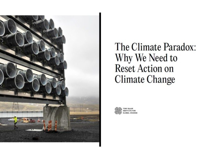 A person walks near large industrial fans at a carbon capture facility; adjacent text reads, "The Climate Paradox: Why We Need to Reset Action on Climate Change and Achieve Net-Zero.
