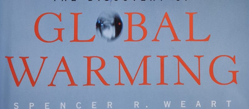 Book cover of the 2003 climate book "The Discovery of Global Warming" by Spencer R. Weart, featuring a blurred swinging pendulum above the word "GLOBAL." A compelling Book of the Year for understanding climate science.