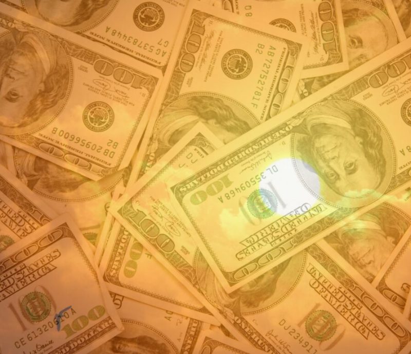 A pile of one hundred dollar bills scattered and overlaid with a warm, golden light effect.