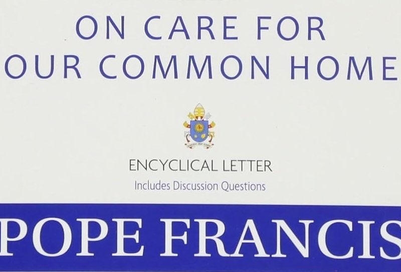 Cover of the 2015 climate book "On Care for Our Common Home," an encyclical letter by Pope Francis, featuring a blue and white design and the Vatican coat of arms.